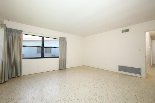 2417 Bayfront Pkwy, Orlando, FL 32806 - unfurnished room featuring speckle patterned floor and baseboards