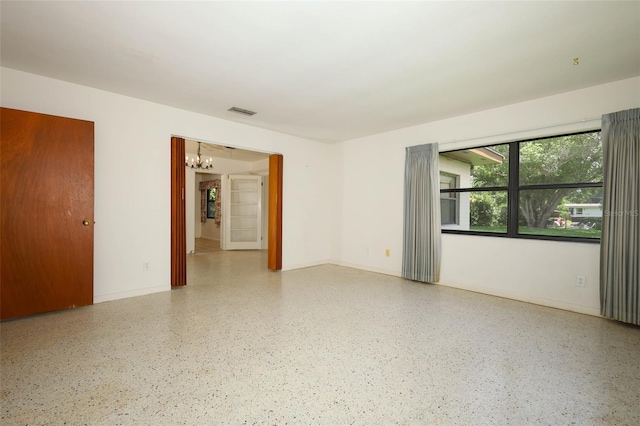 2417 Bayfront Pkwy, Orlando, FL 32806 - spare room with a chandelier and speckled floor