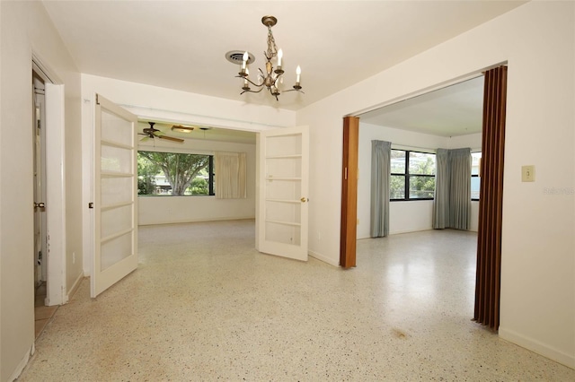 2417 Bayfront Pkwy, Orlando, FL 32806 - corridor featuring a chandelier, french doors, and speckle patterned floor