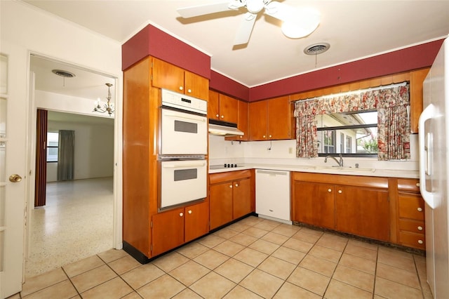2417 Bayfront Pkwy, Orlando, FL 32806 - kitchen with white appliances, light countertops, under cabinet range hood, a ceiling fan, and brown cabinetry