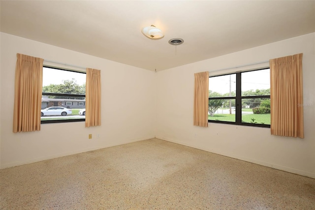2417 Bayfront Pkwy, Orlando, FL 32806 - unfurnished room with speckled floor and baseboards