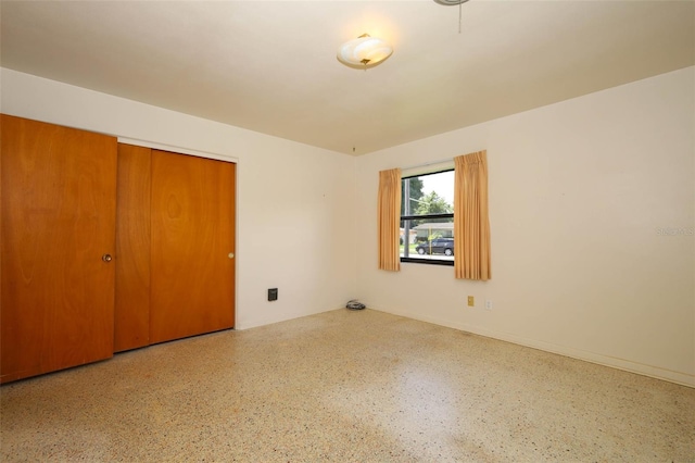 2417 Bayfront Pkwy, Orlando, FL 32806 - unfurnished bedroom with speckle patterned floor and a closet