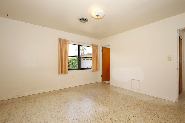 2417 Bayfront Pkwy, Orlando, FL 32806 - empty room featuring speckle patterned floor and baseboards