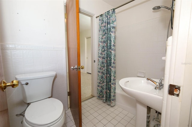 2417 Bayfront Pkwy, Orlando, FL 32806 - bathroom featuring tile walls, shower / bath combination with curtain, tile patterned flooring, and wainscoting