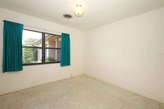 2417 Bayfront Pkwy, Orlando, FL 32806 - empty room with speckled floor and baseboards