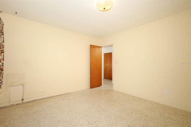 2417 Bayfront Pkwy, Orlando, FL 32806 - empty room featuring speckle patterned floor and baseboards