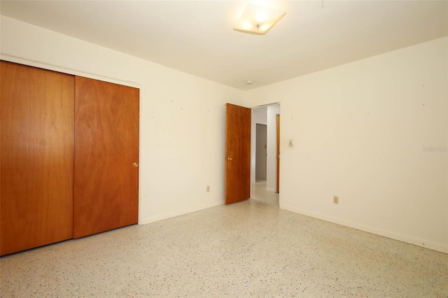 2417 Bayfront Pkwy, Orlando, FL 32806 - unfurnished bedroom featuring a closet and speckled floor
