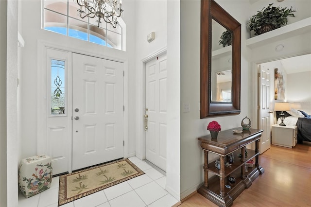 1752 Challenger Ave, Davenport, FL 33897 - entryway featuring a chandelier, a high ceiling, and light tile patterned flooring