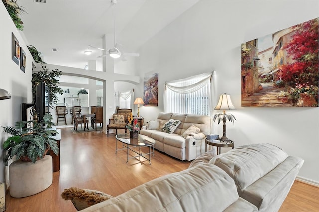 1752 Challenger Ave, Davenport, FL 33897 - living room with arched walkways, a ceiling fan, wood finished floors, and a towering ceiling