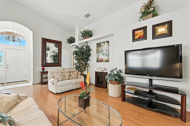 1752 Challenger Ave, Davenport, FL 33897 - living area with lofted ceiling, a chandelier, and wood finished floors