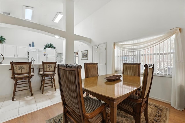 1752 Challenger Ave, Davenport, FL 33897 - dining area with arched walkways, light wood-type flooring, and a towering ceiling