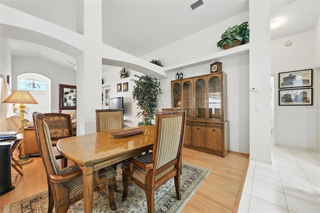 1752 Challenger Ave, Davenport, FL 33897 - dining room with arched walkways, light wood finished floors, and lofted ceiling