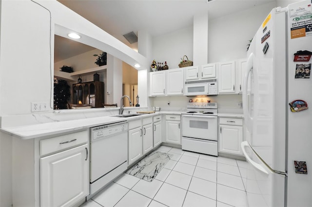 1752 Challenger Ave, Davenport, FL 33897 - kitchen with white appliances, white cabinets, light tile patterned floors, and arched walkways