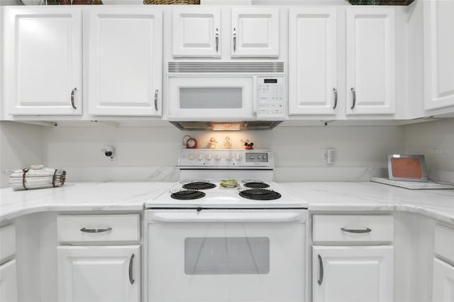1752 Challenger Ave, Davenport, FL 33897 - kitchen with white appliances, white cabinets, and light stone counters