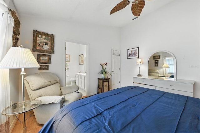 1752 Challenger Ave, Davenport, FL 33897 - bedroom featuring lofted ceiling, connected bathroom, wood finished floors, and a ceiling fan