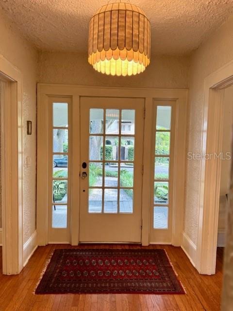 501 Richmond St, Orlando, FL 32806 - doorway with a textured ceiling and wood finished floors