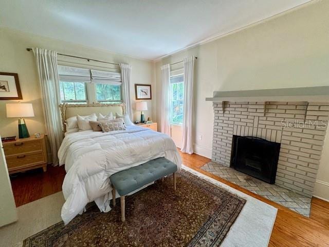 501 Richmond St, Orlando, FL 32806 - bedroom featuring multiple windows, wood finished floors, a fireplace, and crown molding