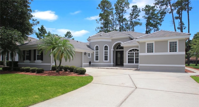 1441 Foxtail Ct, Lake Mary, FL 32746 - view of front of home featuring an attached garage, concrete driveway, a front yard, a tile roof, and stucco siding
