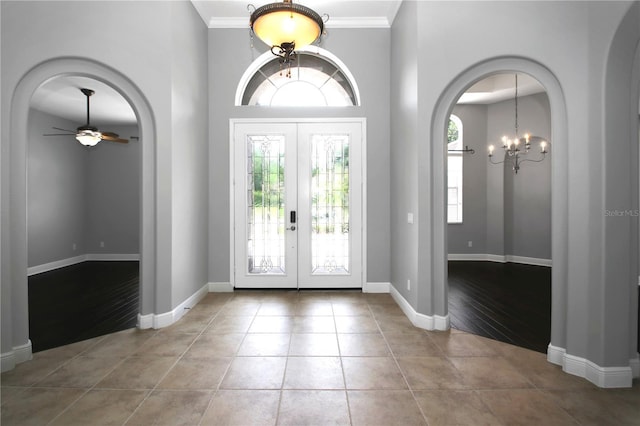 1441 Foxtail Ct, Lake Mary, FL 32746 - tiled entryway featuring a chandelier, french doors, ceiling fan, ornamental molding, and arched walkways