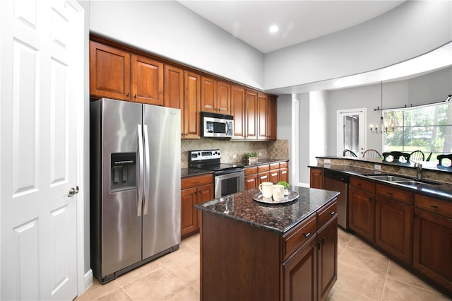 1441 Foxtail Ct, Lake Mary, FL 32746 - kitchen featuring appliances with stainless steel finishes, light tile patterned flooring, backsplash, dark stone countertops, and a kitchen island