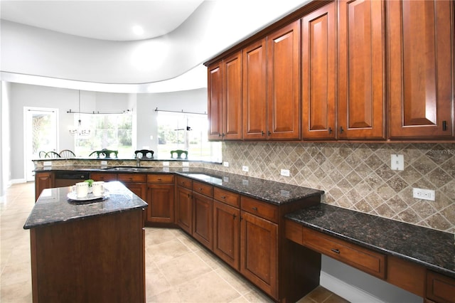 1441 Foxtail Ct, Lake Mary, FL 32746 - kitchen featuring a peninsula, light tile patterned floors, decorative backsplash, and dark stone counters