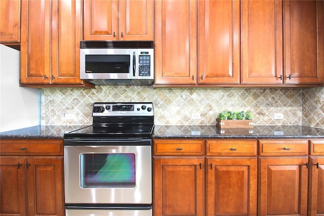 1441 Foxtail Ct, Lake Mary, FL 32746 - kitchen featuring stainless steel appliances, dark stone countertops, decorative backsplash, and brown cabinets