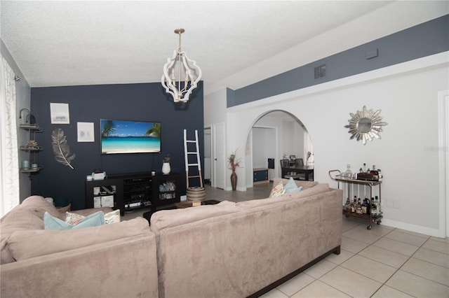 1470 Daniels Cove Dr, Winter Garden, FL 34787 - living room with a chandelier, light tile patterned floors, arched walkways, and lofted ceiling