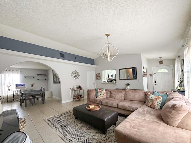 1470 Daniels Cove Dr, Winter Garden, FL 34787 - living area featuring arched walkways, light tile patterned floors, a textured ceiling, and a chandelier