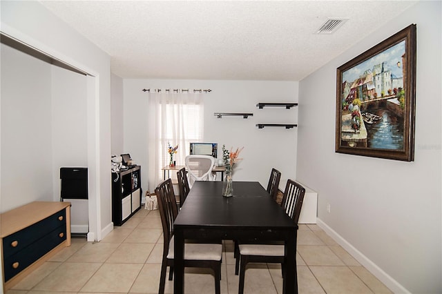 1470 Daniels Cove Dr, Winter Garden, FL 34787 - dining room with light tile patterned floors and a textured ceiling