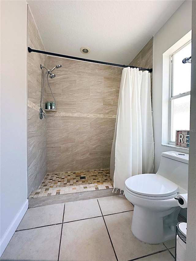 1470 Daniels Cove Dr, Winter Garden, FL 34787 - bathroom featuring a tile shower, tile patterned floors, and a textured ceiling