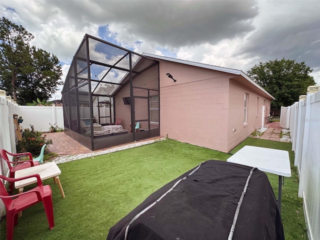 1470 Daniels Cove Dr, Winter Garden, FL 34787 - rear view of house with a fenced backyard, concrete block siding, a lanai, and a patio area