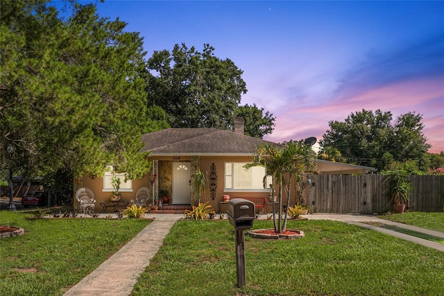 1104 W Marjorie St, Lakeland, FL 33815 - view of front of house with driveway, stucco siding, an attached carport, and a chimney