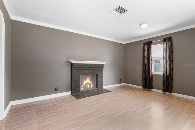 1104 W Marjorie St, Lakeland, FL 33815 - unfurnished living room featuring wood finished floors, a fireplace, and crown molding