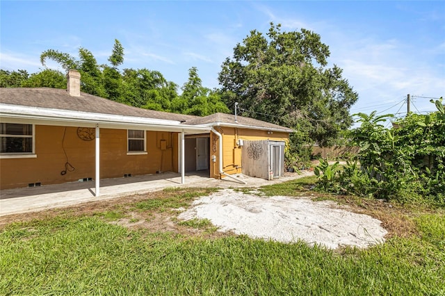 1104 W Marjorie St, Lakeland, FL 33815 - rear view of house with a patio and a chimney