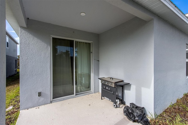 5029 Grand Teton Ct, Deland, FL 32724 - property entrance featuring a patio area and stucco siding