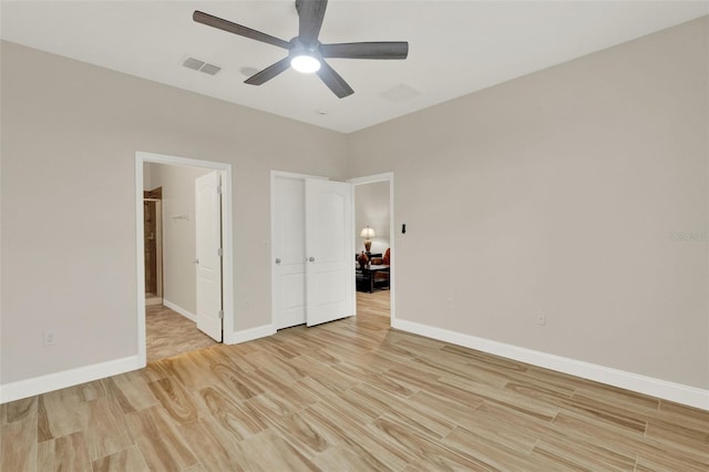 3210 Sonesta Ct Unit B, Clermont, FL 34711 - unfurnished bedroom with light wood-style flooring, connected bathroom, and ceiling fan
