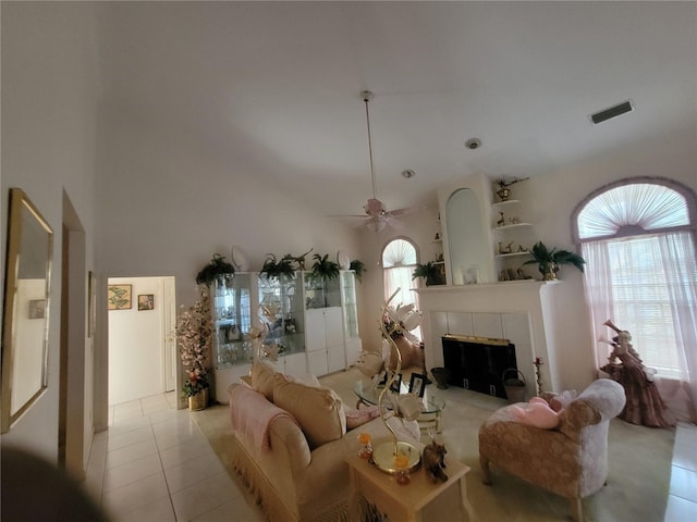 8603 Snowfire Dr, Orlando, FL 32818 - living area featuring tile patterned flooring, a fireplace, ceiling fan, and a towering ceiling