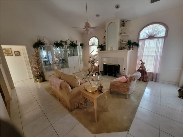 8603 Snowfire Dr, Orlando, FL 32818 - living area with tile patterned floors, a fireplace, and a ceiling fan