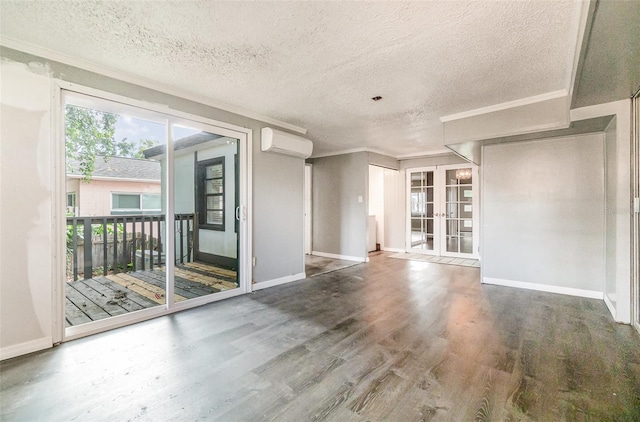 1422 Russell Ave, Orlando, FL 32806 - unfurnished room featuring french doors, wood finished floors, a wall mounted AC, crown molding, and a textured ceiling