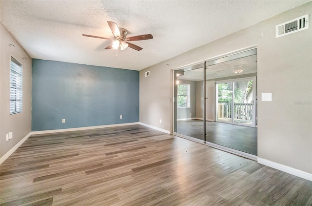 1422 Russell Ave, Orlando, FL 32806 - spare room with a ceiling fan, wood finished floors, and a textured ceiling