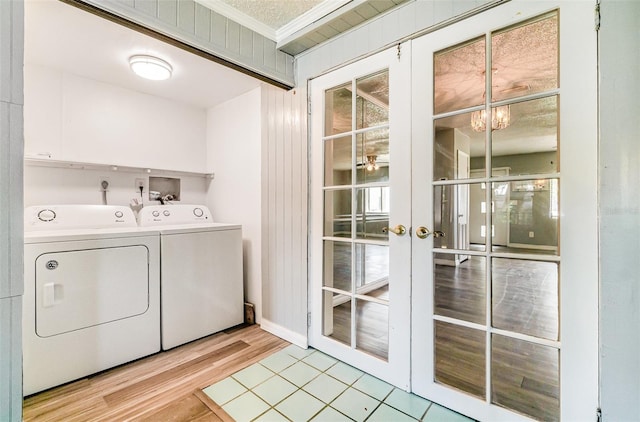 1422 Russell Ave, Orlando, FL 32806 - laundry area with washer and dryer, french doors, light wood finished floors, ornamental molding, and a chandelier