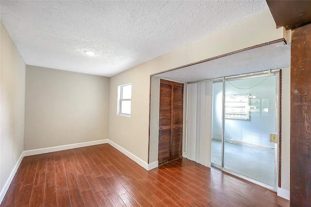 1204 Marie Ave, Apopka, FL 32703 - unfurnished bedroom with a closet, a textured ceiling, and wood finished floors