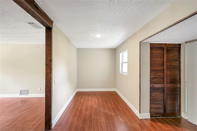 1204 Marie Ave, Apopka, FL 32703 - unfurnished bedroom with wood finished floors, a textured ceiling, and a closet