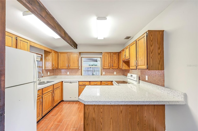 1204 Marie Ave, Apopka, FL 32703 - kitchen featuring white appliances, backsplash, a peninsula, beamed ceiling, and light wood finished floors