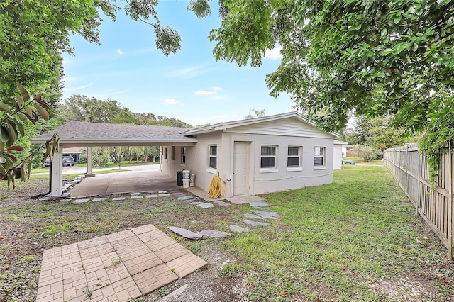 1204 Marie Ave, Apopka, FL 32703 - back of property featuring a patio area, an attached carport, and concrete block siding