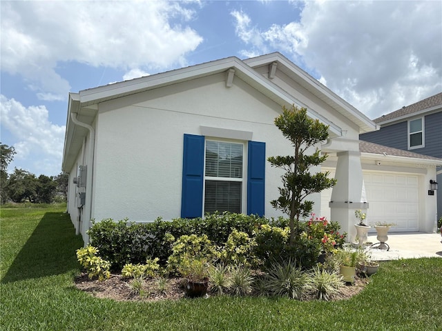 873 Daring Dr, Davenport, FL 33837 - view of home's exterior featuring a garage, a lawn, stucco siding, and concrete driveway