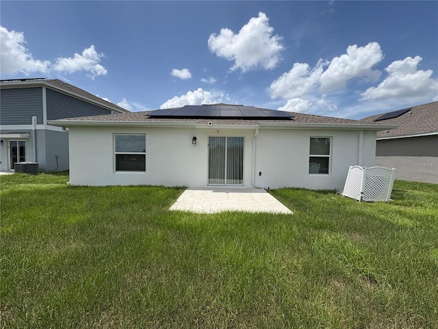 873 Daring Dr, Davenport, FL 33837 - rear view of house with solar panels, stucco siding, and a yard