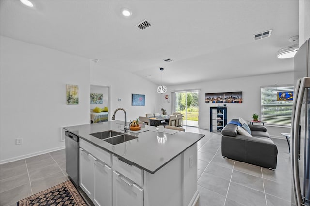 873 Daring Dr, Davenport, FL 33837 - kitchen featuring stainless steel appliances, light tile patterned flooring, open floor plan, a center island with sink, and white cabinetry