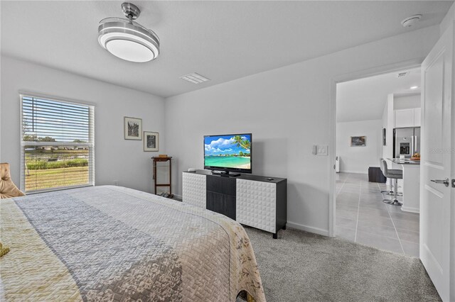 873 Daring Dr, Davenport, FL 33837 - carpeted bedroom featuring stainless steel refrigerator with ice dispenser and tile patterned flooring