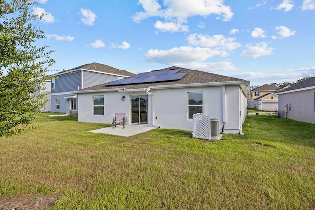 873 Daring Dr, Davenport, FL 33837 - rear view of property featuring a patio area, a yard, roof mounted solar panels, and stucco siding
